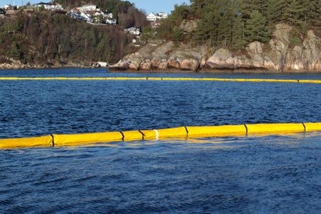 Yellow Ecosolid Containment Boom, deployed in blue ocean.